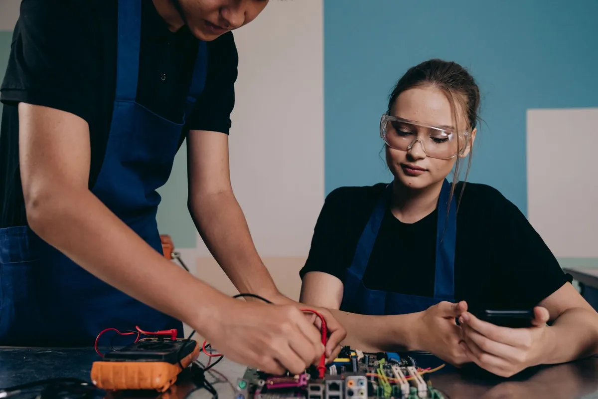 Hands-on electronics work with a circuit board and test equipment